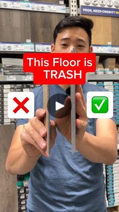 a man holding up a red sign that says this floor is trash and check boxes