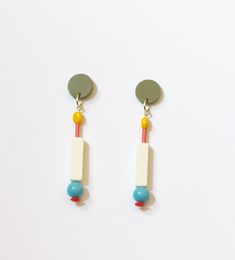 These cool classics are right at the intersection where minimal meets FUN. The acrylic green posts lend a strong foundation to the yellow, coral, off white, aqua and red beads that dangle down. They're lightweight, comfortable and easy to wear--but still make a statement!  Length: 3" At Supercute, we try super hard to use sustainable, recycled, and/or upcycled materials. We source vintage beads from estate sales, garage sales, our local craft swap, our own collection -- and even Etsy! Each piece is designed, hand assembled, packaged and sent to you from our studio in Arlington Heights, Illinois.  Our jewelry makes for wonderful and unique gifts. If you'd like a free gift wrap, please leave that in a comment and we'll gift wrap the box before shipping! Modern Multicolor Earrings For Everyday, Minimalist Yellow Earrings For Pierced Ears, Minimalist Yellow Pierced Earrings, Minimalist Multicolor Dangle Earrings, Modern Yellow Earrings For Everyday, Modern Yellow Earrings For Everyday Wear, Multicolor Earrings, Earrings Colorful, Red Beads