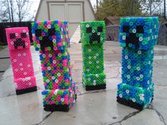 four different colored lego blocks sitting on top of a stone floor