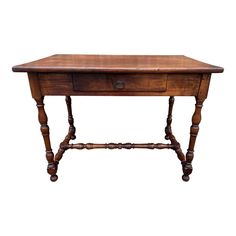 an old wooden table with two drawers on one side and three legs at the top