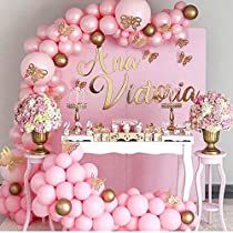 a pink and gold birthday party with balloons