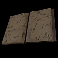 an open book with writing on it in the middle of black background, which appears to have been altered