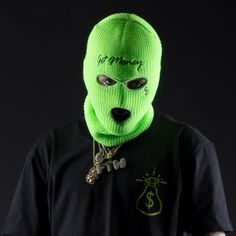 a man wearing a neon green knitted mask with the word money written on it