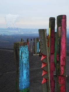 colorful wooden posts on top of a hill