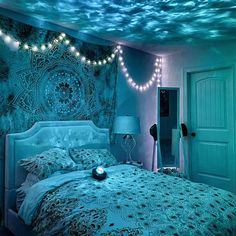 a bed room with a neatly made bed and string lights on the wall above it