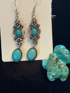 Turquoise and silver on a 2.5" dangle earring set. Stainless steel. Turquoise Teardrop Jewelry Set, Turquoise Teardrop Jewelry With Matching Earrings, Turquoise Teardrop Pierced Jewelry, Turquoise Teardrop Pierced Earrings, Pierced Turquoise Teardrop Jewelry, Elegant Turquoise Metal Chandelier Earrings, Turquoise Metal Dangle Jewelry, Turquoise Dangle Metal Jewelry, Turquoise Teardrop Metal Jewelry