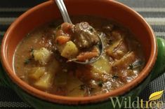 a close up of a bowl of food with a spoon in it