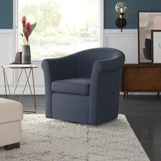 a living room with blue walls and white rugs on top of the wooden floor