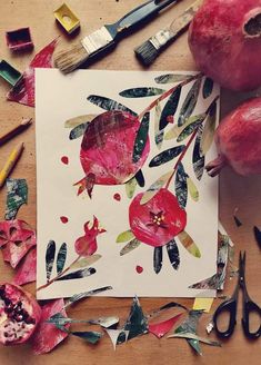 an art project with paper, scissors and pomegranates on a table