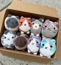 a cardboard box filled with small crocheted animals