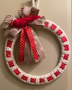 a red and white wreath hanging on the wall