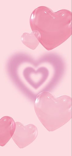 three pink hearts floating in the air