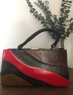 "1960s 1970s Dover Handbag, Vintage Top Handle Purse, Vintage Accessory Retro 1960s 1970s handbag with an unusual wave design on the front of the bag in multiple colors and solid black on the back of the bag. Doubled black handle strap. Gold tone metal frame with a thumb lift closure that works well and closes tightly with that lovely \"snapping\" sound letting you know that everything inside is safe and secure. Opens to black fabric lining with three compartments.  Two on the outer side of the Retro Red Rectangular Shoulder Bag, Retro Vintage Brown Rectangular Shoulder Bag, Retro Red Top Handle Shoulder Bag, Red Retro Top Handle Shoulder Bag, Retro Brown Satchel, Retro Red Top Handle Satchel, Retro Red Satchel Shoulder Bag, Retro Red Shoulder Satchel, Retro Red Rectangular Satchel