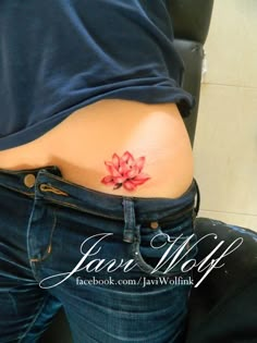 a woman with a flower tattoo on her stomach