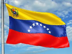 the flag of venezuela is flying high in the sky