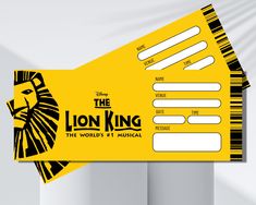 the lion king ticket is on display in front of a white wall with black and yellow stripes