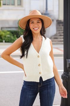 We are certain that you'll be obsessed with styling the Cozy Guarantee Ivory Sweater Vest this season! This versatile piece is crafted from a soft, cozy knit that provides warmth without compromising on style. The classic ivory color makes it a perfect neutral that pairs seamlessly with a variety of outfits. Featuring a button-up front and a slightly oversized fit, this vest adds a relaxed yet polished look to your ensemble. Style it over a crisp button-up shirt for a chic office outfit, or wear it over a casual tee for a laid-back weekend vibe. With its timeless design, this sweater vest is a must-have for every wardrobe! Soft + Stretchy Knit Fabrication V-Neckline Functional Button Front Sleeveless Relaxed Fit 60% Cotton, 40% Acrylic Hand Wash Cold, Line Dry Model is 5'4" and wearing a S Chic Office Outfit, Ivory Sweater, Office Outfit, Chic Office, Cozy Knit, Cozy Knits, Casual Tee, Office Outfits, Ivory Color