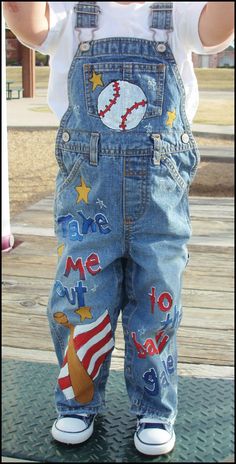 Custom painted baseball game birthday overalls for toddler boys. Perfect for an all American baseball themed birthday party. Painted with stars of gold and red, white and blue stripes, baseballs, a bat and a baseball cap along with the lyrics of the song, Take me out to the Ballgame! I am pulling some of my very first original designs out of my design vault/portfolio. :) Every little boy would love to wear these precious hand painted denim dungarees with their favorite sport on them. I can even Baseball First Birthday Outfit, Painted Overalls, Kai Aesthetic, Redo Clothes, Decorate Clothes, Red Overalls, Recycled Clothes, Pig Pen, Clothes Embroidery Diy