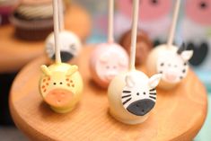 cake pops with animals on them sitting on a table