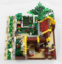 a lego model of a small house made out of legos, including a tree