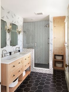 a bathroom with two sinks and a walk in shower