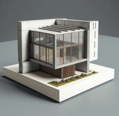 an architectural model of a building with windows and grass on the ground in front of it