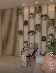 a living room filled with lots of plants next to a wall mounted planter on the wall