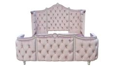 an upholstered bed with pink velvet and silver trimmings