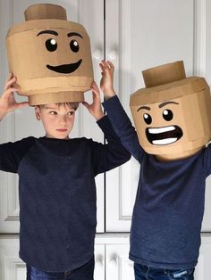 two young boys wearing paper bags with faces on them