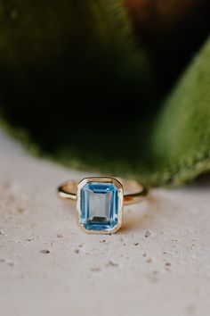 a ring with an aqua blue stone on it