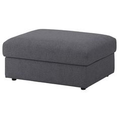 a grey ottoman that is sitting on the ground