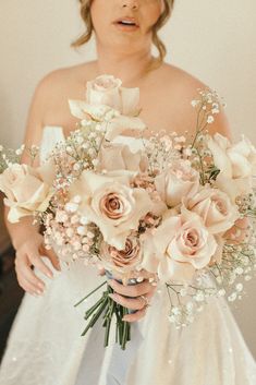 a woman holding a bouquet of flowers in her hands