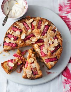 a dessert with almonds and raspberries on a white plate