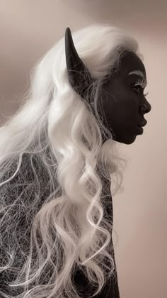 a woman with long white hair and horns