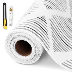 a white wallpaper with black lines on it and a ruler next to it,