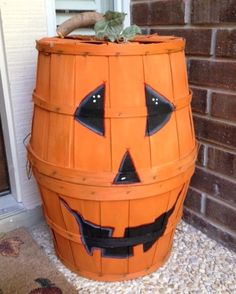 a wooden barrel with a jack - o'- lantern face painted on it