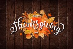 happy thanksgiving day with leaves on wood background