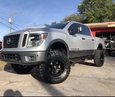 a silver truck parked in a parking lot