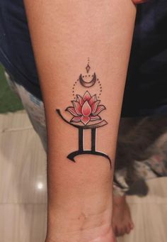 a woman's arm with a lotus tattoo on it