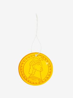 a yellow coin with a woman's face on it hanging from a white string