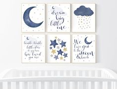 four blue and white nursery wall art prints with stars, clouds, and the moon