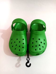 This Crocs shoe boasts a slip-on closure, making it easy to wear and take off. It features a green color and a classic clog style, providing comfort and style for teens and women. The shoe is designed with the Crocs brand, ensuring durability and quality. The shoe is perfect for casual wear, and the size 4 for women and size 2 for juniors make it accessible to a wide range of individuals. The comfortable design makes it suitable for all-day wear, and the Crocs Classic Clog is a must-have addition to any wardrobe. Casual Green Closed Toe Slip-ons, Green Slip-ons With Rubber Sole For Summer, Green Non-slip Casual Slippers, Green Casual Slippers With Cushioned Footbed, Comfortable Green Synthetic Slippers, Casual Green Non-slip Slippers, Comfortable Green Non-slip Sandals, Comfortable Non-slip Green Sandals, Green Non-slip Casual Sandals