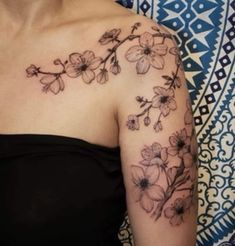 a woman's shoulder with flowers on it