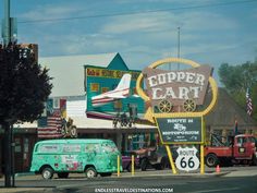 an old green van is parked in front of a sign that says uppercart