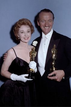 a man and woman posing with their oscars