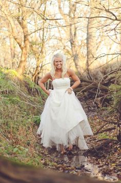 a woman in a wedding dress standing on a path