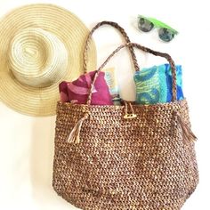 a straw hat, beach bag and sunglasses on a white background