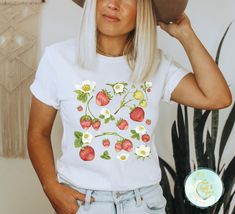 Strawberry Shirt, Strawberry Clothes, Strawberry Top, Garden Shirt, Aesthetic Clothing, Cottagecore Clothes, Cottage Core, Botanical Shirt, Strawberry Print, Gardening Shirts, Gardener Gifts, Summer Berry Tee, Floral Graphic Tee Get ready, this shirt is about to become your favorite! Made of super soft cotton with a comfy fit, you'll find it fits in with all your outfits! The details: Super Soft Pre-shrunk Cotton Tee Unisex - Fits true to size (see size chart for references of length and width) Strawberry Clothes, Clothing Cottagecore, Aesthetic Cottage Core, Gardener Gifts, Strawberry Aesthetic, Aesthetic Cottage, Garden Shirt, Strawberry Shirt, Cottagecore Clothes