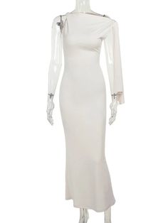 a mannequin wearing a white dress with long sleeves