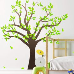 a tree with green leaves on it in a child's room